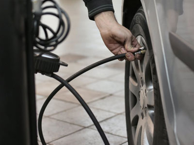 Mechanic pumping tyres