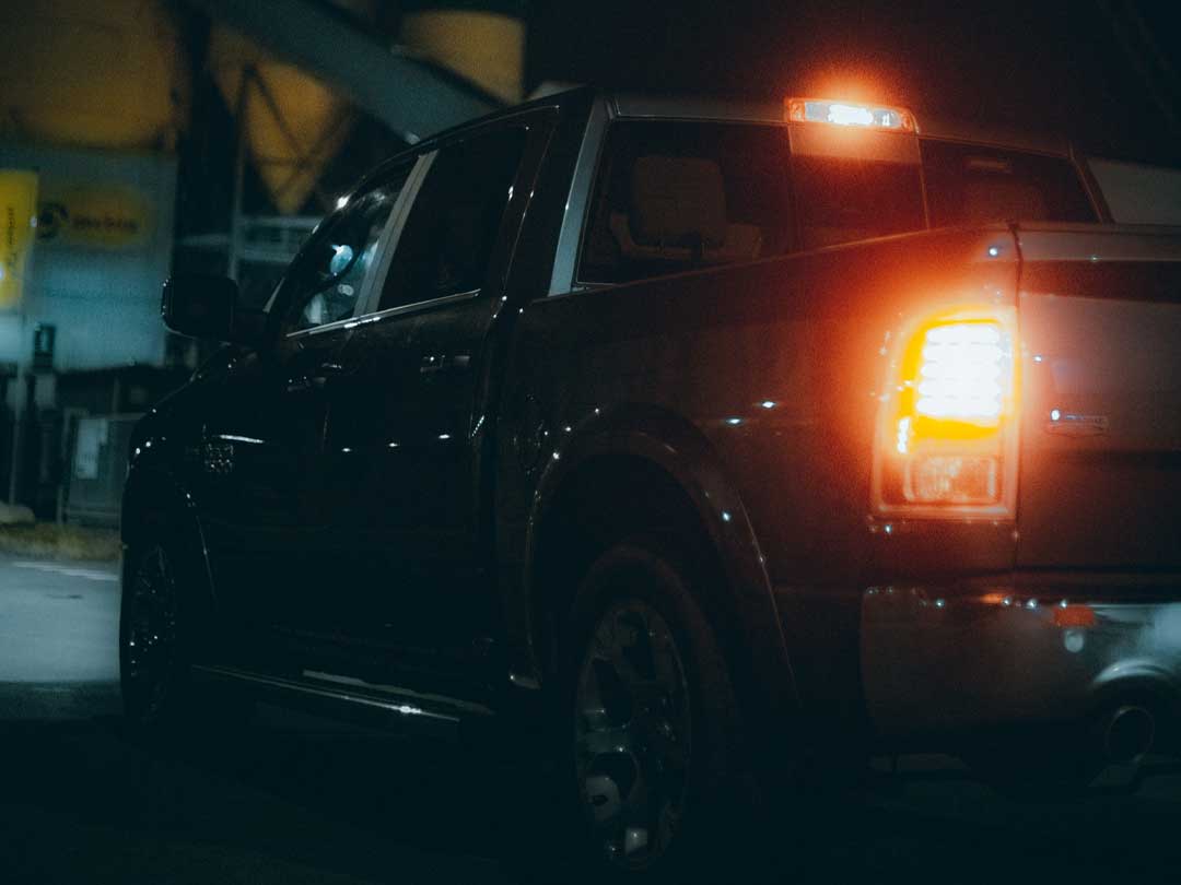 A pickup truck tail light glowing in the dark