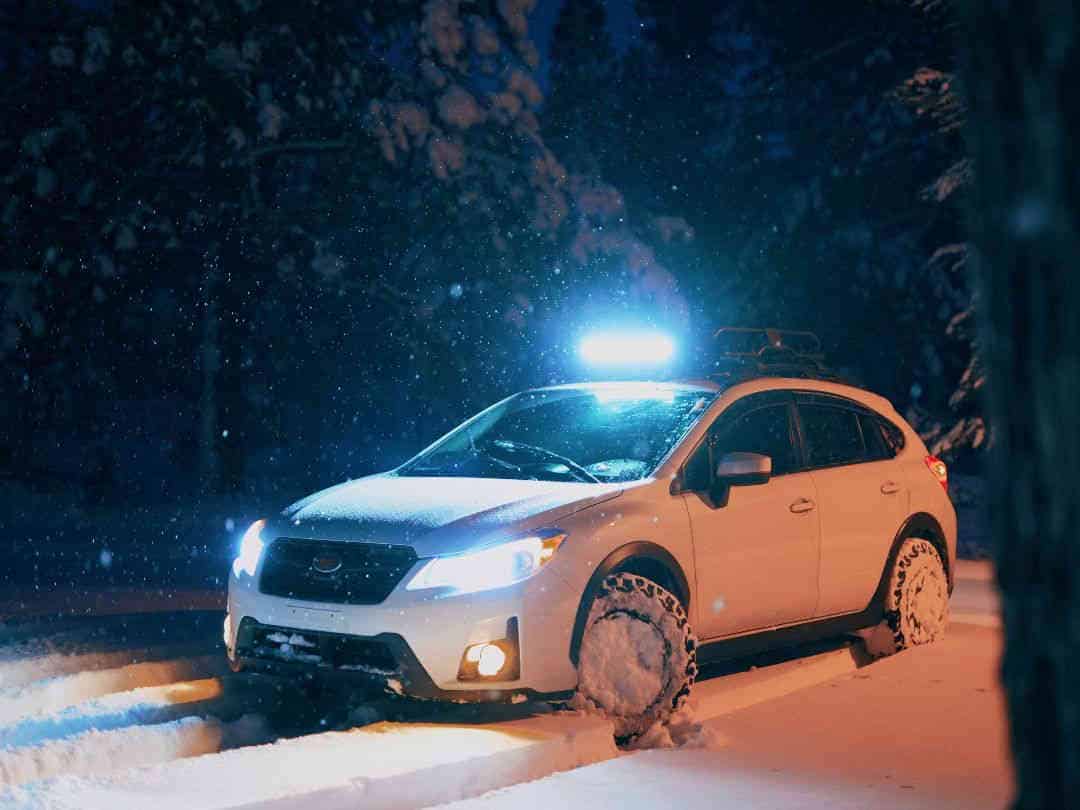 white SUV on snow covered road